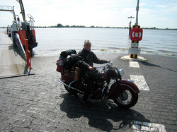 Me with heavy luggage at the shore of the River Elbe